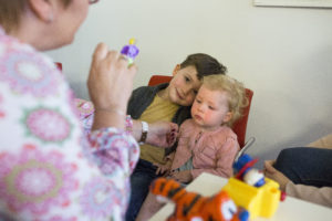 Dr Sandra Staffieri performs an eye test on a little boy and girl.