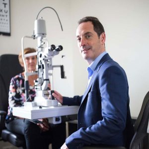 Keith with patient in eye scanner