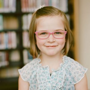 Young girl with pink glasses
