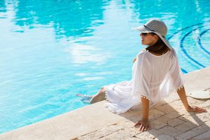 Woman sitting by the pool