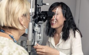 Dr Jennifer Fan Gaskin doing eye test on female patient