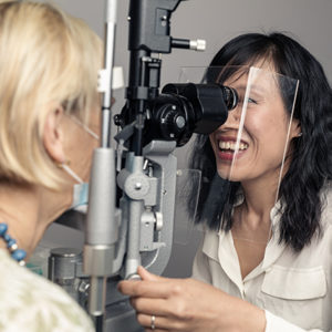 Dr Jennifer Fan Gaskin performing an eye test on a female patient