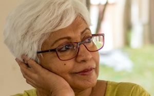 Older female of Asian descent wearing glasses