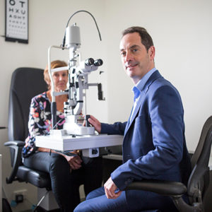 Keith with patient in eye scanner