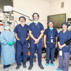 Research team in scrubs in an operating theatre