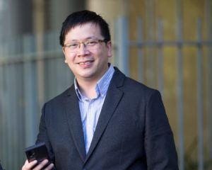 George Kong holiding a mobile phone
