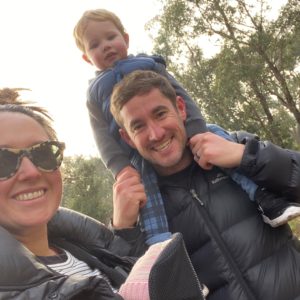 Shelley and Will Alderman with their son Noah. Noah is sitting on Will's shoulders.