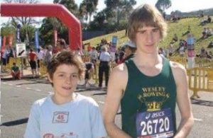 A young Billy Morton stands with his cousin, Paralympian Sam Harding. Both have choroideremia and look like they've been competing in a marathon. The picture is from 2009.