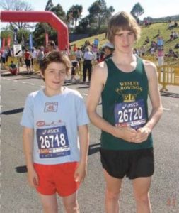 A young Billy Morton stands with his cousin, Paralympian Sam Harding. Both have choroideremia and look like they've been competing in a marathon. The picture is from 2009.