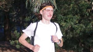 Billy Morton, a young man with the rare genetic eye disease choroideremia, is running. He is wearing sportswear and looks like he's training for a marathon.