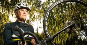 Photo of Jenny Hassell standing alongside her bike.