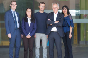 Photograph of some of CERA's glaucoma researchers standing face to camera in front of the Royal Victorian Eye and Ear Hospital entrance.