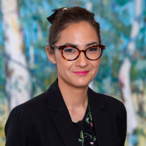 Head and shoulders photograph of Dr Michelle Waugh standing face to camera, smiling.