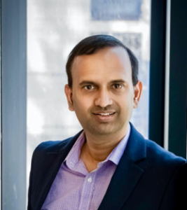 Head and shoulders photograph of Associate Professor Sandeep Reddy, face to camera, smiling.