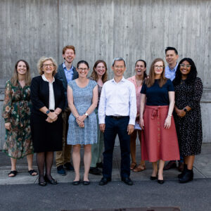 Nine people part of our Macular Research Unit, standing together.