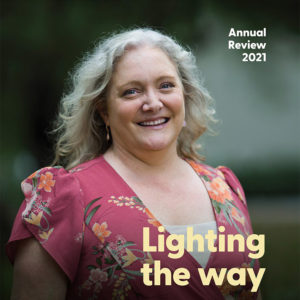 Front cover of the CERA 2021 Annual report. It is titled Lighting the way, and features a head and shoulders shot of Sophie Thomas smiling towards the camera.