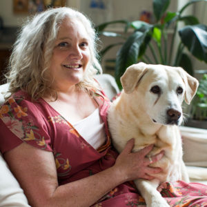 Sophie and her dog Yarra, sitting on a couch