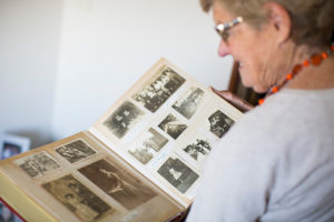 An over the shoulder shot of Jenny flocking through a photo album