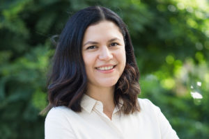 Dr Isabel Lopez Sanchez, standing outside, smiling, facing the camera