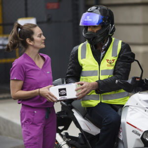 LEDS Coordinator Prue Armstrong hands over the precious cargo to Bloodbikes volunteer Rob Chrisomalidis