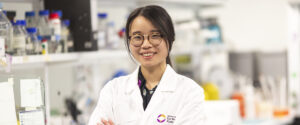 Smiling headshot of Dr Anna Wang in a laboratory.